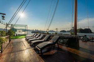 a group of chairs sitting on the deck of a boat at Mila Lux Cruises in Ha Long