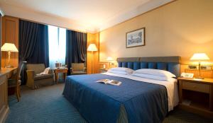 Postel nebo postele na pokoji v ubytování Grand Hotel Barone Di Sassj