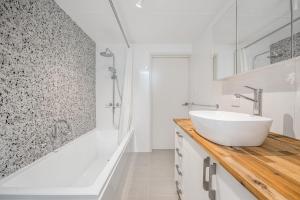 a white bathroom with a sink and a shower at Chateau McNally in Lancelin
