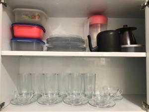 a bunch of empty glasses sitting on a shelf at CASA EM BH Santa Efigênia in Belo Horizonte