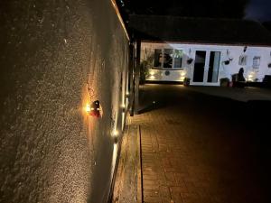 a light on the side of a wall at night at Shropshire Guesthouse in Wolverhampton