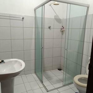 a bathroom with a shower and a toilet and a sink at Casa temporada in Baía Formosa