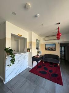 a living room with a couch and a red rug at St Kilda Accommodation in Melbourne