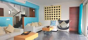 a living room with a couch and a chair at Villa Horizon by Dream Escapes, Beachfront Villa in Pointe aux Cannoniers +36 photos