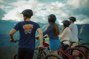 a group of people standing on a mountain with bikes at Ecoterra Inka Lodge Shared Rooms in Quillabamba +18 photos
