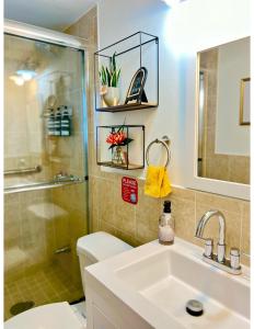 a bathroom with a shower and a sink and a toilet at Lush tropical big home close to Airport, Calle 8, Coral Gables and lots more Miami amenities in Miami