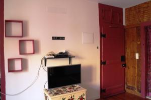 a room with a tv and a red door at Rossio Castle View in Lisbon