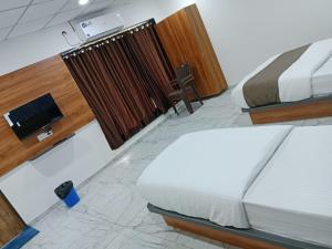 Hotel Rudraksh客房内的一张或多张床位