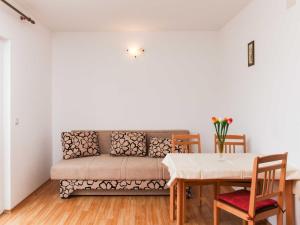 a living room with a couch and a table at Apartments Ana Lopud - One Bedroom Apartment with Balcony and Sea View - 3 1 floor in Lopud Island +8 photos