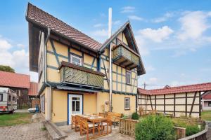 a house with a table and chairs in front of it at Apartments am Hainich - 6 Personen, King-Size-Betten, Netflix, Nationalpark in Hörselberg-Hainich