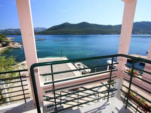 a balcony with a view of the water at Apartments Ere Zuronja-One-Bedroom Apartment with Sea View 2 in Putniković +3 photos