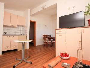 a living room with a kitchen and a dining room at Apartments Ere Zuronja-One-Bedroom Apartment with Sea View 2 in Putniković