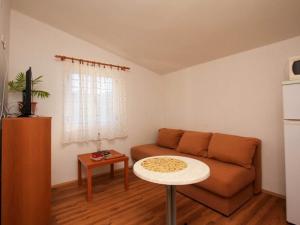 a living room with a couch and a table at Apartments Ere Zuronja-One-Bedroom Apartment with Sea View 2 in Putniković