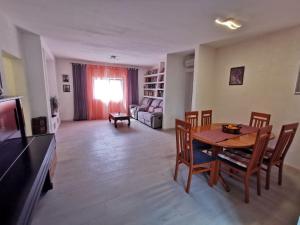 ein Wohnzimmer mit Tisch, Stühlen und Sofa in der Unterkunft Apartment Nera ST - Two-Bedroom Apartment with Sea View in Omiš