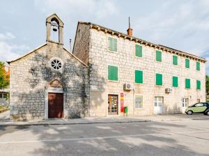 an old brick building with a clock tower on it at Apartment Magdalena - Three Bedroom Apartment in Nerežišća