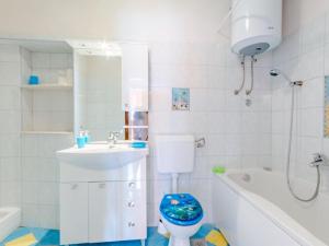 a bathroom with a toilet and a sink and a tub at Apartment Magdalena - Three Bedroom Apartment in Nerežišća +19 photos
