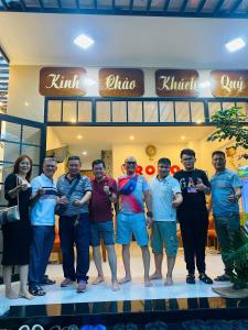 a group of people standing in front of a store at Romo Homestay in Quảng Ngãi
