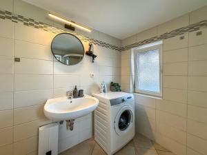 ヴォルフスブルクにあるR und S Apartments Stylische Wohnung I Küche I Parkplatz I Smart TVの洗面台と洗濯機を備えたバスルーム +19枚の写真