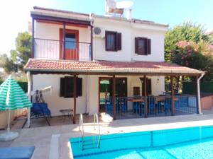 a house with a swimming pool next to a house at Villa calış 2 in Fethiye