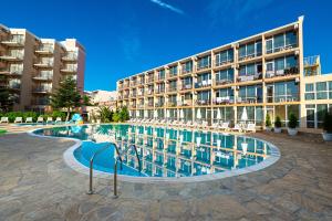 a swimming pool in front of a building at Hotel Riva Park - All Inclusive in Sunny Beach