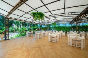 a banquet hall with white tables and chairs at Hotel Riva Park - All Inclusive in Sunny Beach