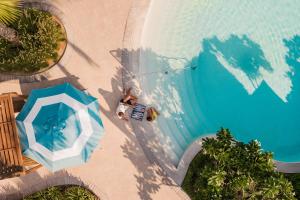 an overhead view of a swimming pool with an umbrella at Jumeirah Beach Hotel Dubai in Dubai