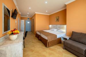 a hotel room with a bed and a couch at Hotel Riva Park - All Inclusive in Sunny Beach