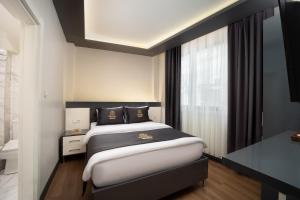 Postel nebo postele na pokoji v ubytování Bakırköy Zeugma Suit Otel