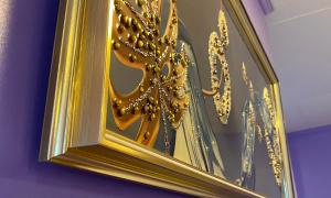 a gold mirror with a bunch of gold chains at Drossgold Pension House in Tubigon