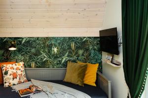 a bedroom with a bed with a green wall at Žalia kopa with pool in Palanga