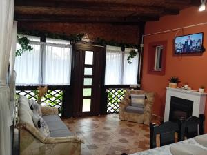 a living room with a couch and a fireplace at Căsuța Piatra Craiului in Zărneşti +23 photos