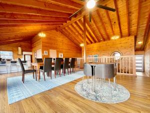 a dining room with a table and black chairs at Treetops Retreat Katoomba in Katoomba
