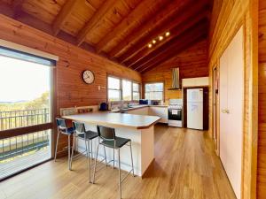 a kitchen with a counter and a large window at Treetops Retreat Katoomba in Katoomba