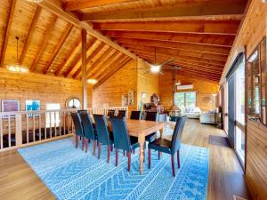 a dining room with a wooden table and chairs at Treetops Retreat Katoomba in Katoomba
