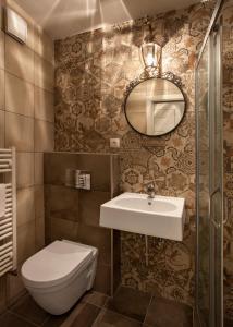 a bathroom with a sink and a toilet and a mirror at Igor and David Apartments in Prague