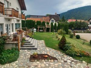 a backyard of a house with a garden and a house at The Brothers House Bran in Bran