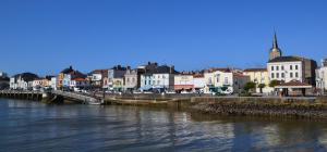 a town next to a river with a bridge at Hôtel Les Embruns Sables d'Olonne in Les Sables-d'Olonne