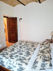 a bedroom with a bed with a blue and white comforter at Domus Pia in Rocca Pia +21 photos