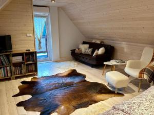 a living room with a large bear rug on the floor at Sidka & Adam in Liptovský Ján