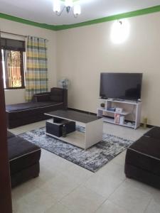 TV a/nebo společenská místnost v ubytování Palm Suites