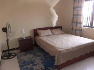 Postel nebo postele na pokoji v ubytování Palm Suites