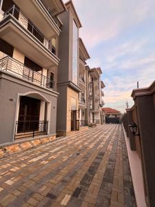 an empty street in front of a building at Abba Homes in Bulambiro