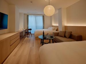 a hotel room with a bed and a couch at THE SENSE HOTEL TOKYO in Tokyo