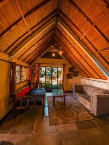 an attic room with a couch and a table at Sipi Falls Lodge in Sipi