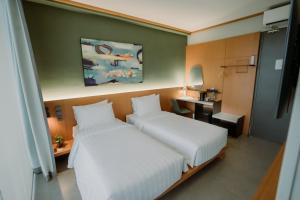 Voodi või voodid majutusasutuse Jiro Hotel toas