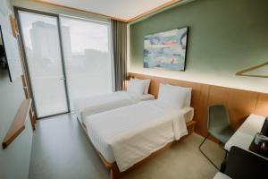 Voodi või voodid majutusasutuse Jiro Hotel toas
