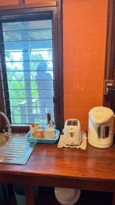 Una encimera con una tostadora y una tostadora encima. en Cheriya bungalow Kohyaonoi, en Ban Laem Sai