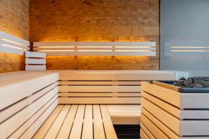 an empty sauna with wooden walls and wooden floors at Chalet VIE in Viehhofen