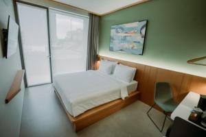 Voodi või voodid majutusasutuse Jiro Hotel toas
