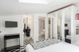 a white bedroom with a bed and a bathroom at The Roof Sorrento in Sorrento